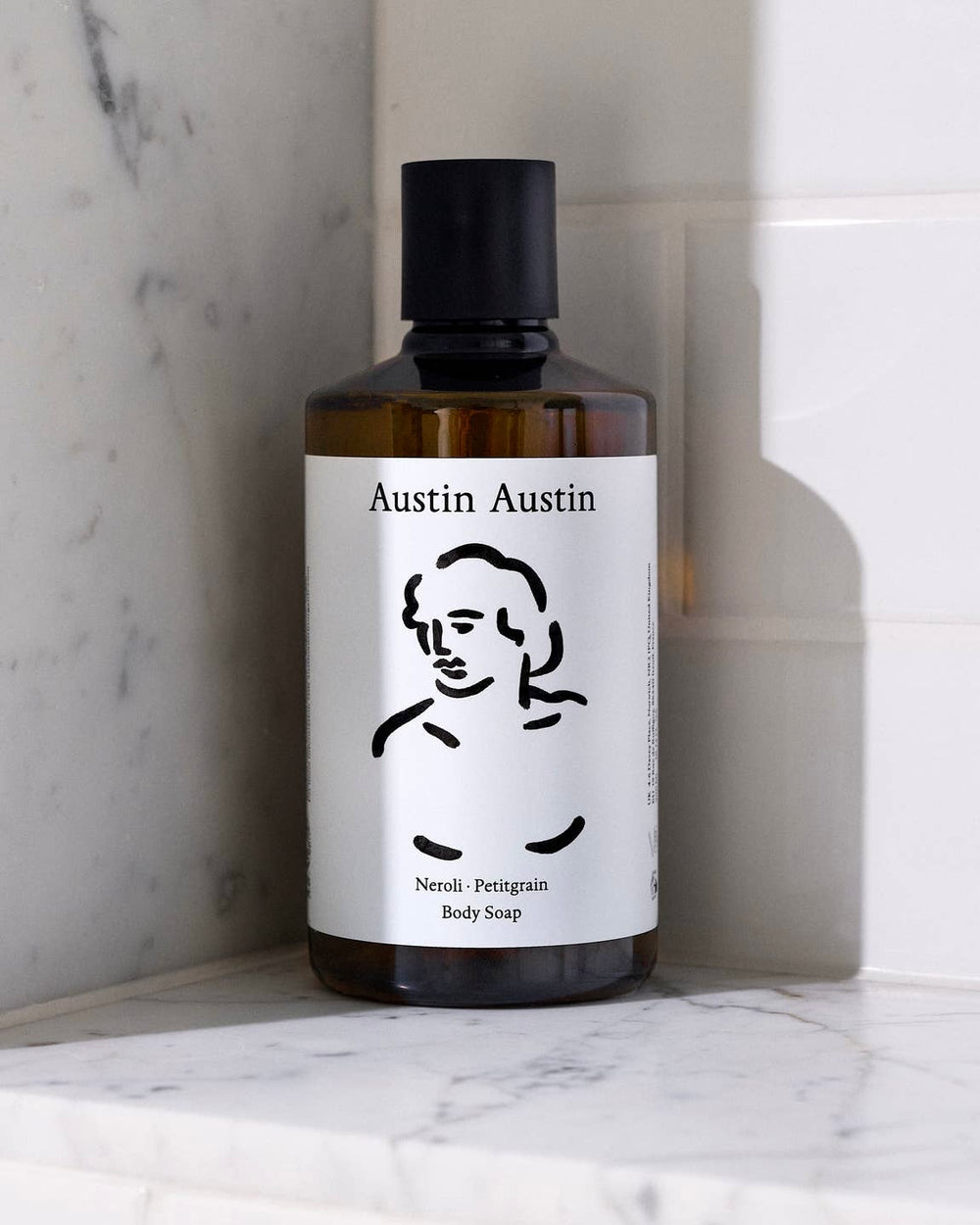 Bottle of Austin Austin body soap on a marble surface