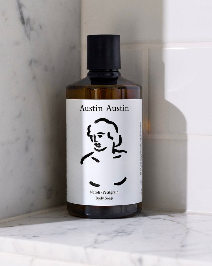 Bottle of Austin Austin body soap on a marble surface